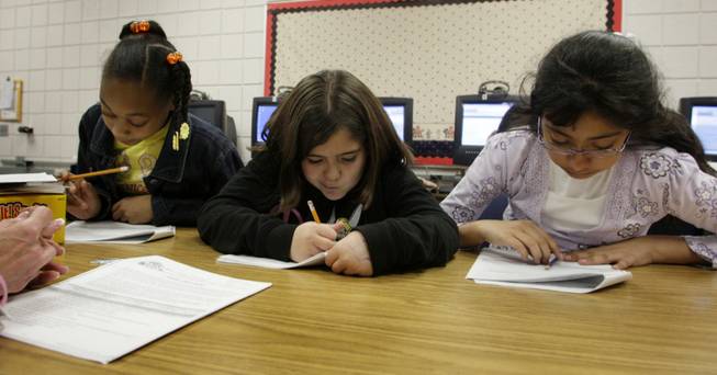 Students, from left, Alanna Holmes, Jennifer Lopez and Joelda Segovia use a Response to Intervention lab at Adams Elementary, an empowerment school, in February.