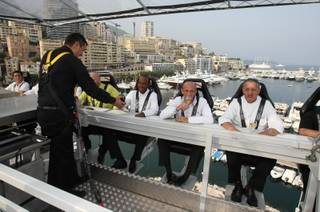 Star-rated chefs sit at a table suspended at a height of 30 meters (about 98 feet), above the harbour of Monaco, Friday, July 9, 2010, as they test out the privileged diner facilities on this high-flying restaurant at the heart of the Monaco Principality.  