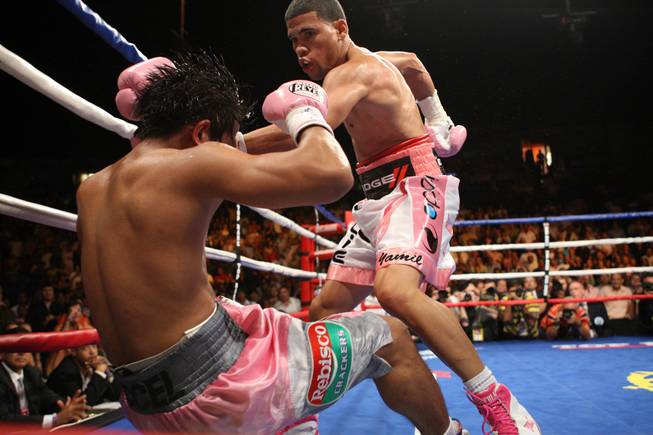 Juan Manuel Lopez drops Bernabe Concepcion during their WBO featherweight title fight in Puerto Rico on July 10, 2010. Lopez won by TKO in the second round.