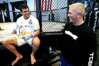Brazilian middleweight Vitor Belfort jokes with trainer Shawn Tompkins before a workout Wednesday, July 14, 2010.