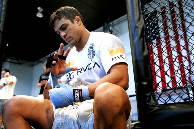 Brazilian middleweight Vitor Belfort tapes up his hands before a workout at TapouT Wednesday, July 14, 2010.