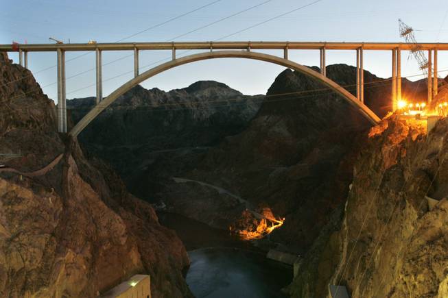 Construction on the Hoover Dam Bypass bridge, shown Wednesday, is scheduled to be finished in September.