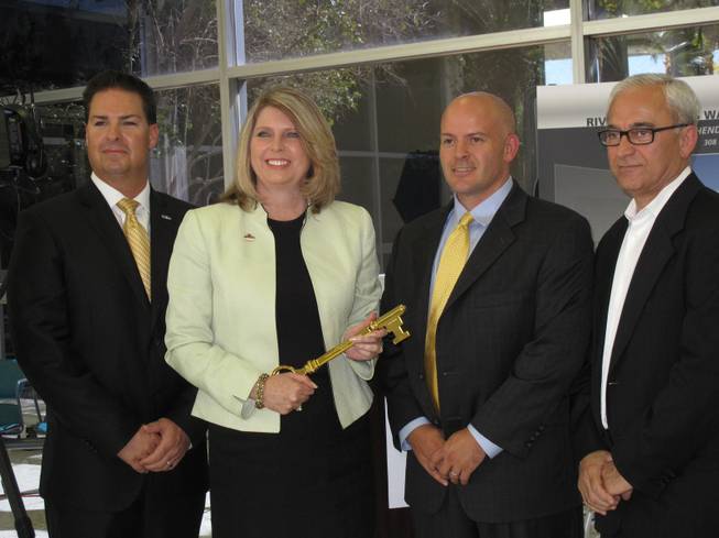 Officials pose after announcing that Amonix, a solar power company, will locate a manufacturing plant in North Las Vegas. The plant will create 278 jobs. Pictured are (left to right) Vice President of Economic Development for the Nevada Development Authority Christopher Zunis, North Las Vegas Mayor Shari Buck, Amonix CEO Brian Robertson and Amonix Senior Vice President of Marketing Operations Vahid Ghassemian.