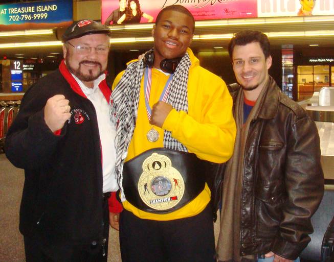 Las Vegas amateur boxer Deyon Christie (middle) poses with coaches Pat Barry (left) and Augie Sanchez (right).