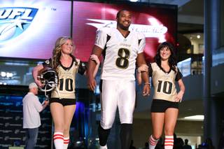 Sacramento Mountain Lions quarterback Daunte Culpepper walks down the runway in his team's new uniform Wednesday at the Fashion Show Mall. The UFL held an event to unveil all five teams' uniforms for the 2010 season. 