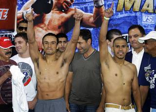 WBA/WBO lightweight champion Juan Manuel Marquez, left, of Mexico City and Juan Diaz of Houston, Texas pose during an official weigh-in at the Mandalay Bay Events Center Friday, July 30, 2010. The boxers meet for a rematch at the events center on Saturday.