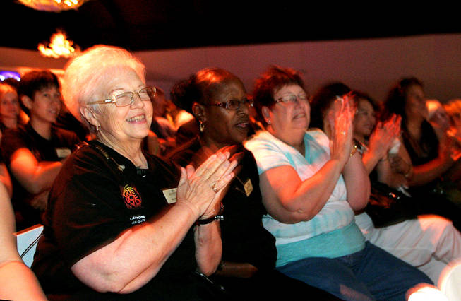 Silverton employees cheer as President Craig Cavileer announces that pay cuts they had taken would be incrementally restored during a meeting Friday, July 30, 2010.