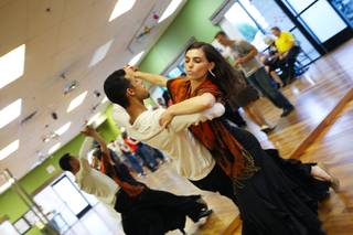 As music plays in the background, competitors Hannah Lopez, 21, and Jonathan Bailey, 20, swirl around the dance floor concentrating on each move while practicing at Dance Charisma school for an upcoming competition.  Lopez and Bailey have been competitive dance partners for 2 1/2 months.