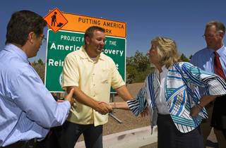 Bren Wick, project manager for Las Vegas Paving, shakes hands with Rep. Dina Titus (D-Nev.) during a news conference in Henderson Thursday, August 5, 2010. Also pictured are Rep. Xavier Becerra, left,  (D-Calif.) and Henderson Mayor Andy Hafen. The event heralded the completion of the Green Valley Parkway repaving project, which was paid for with federal stimulus money.