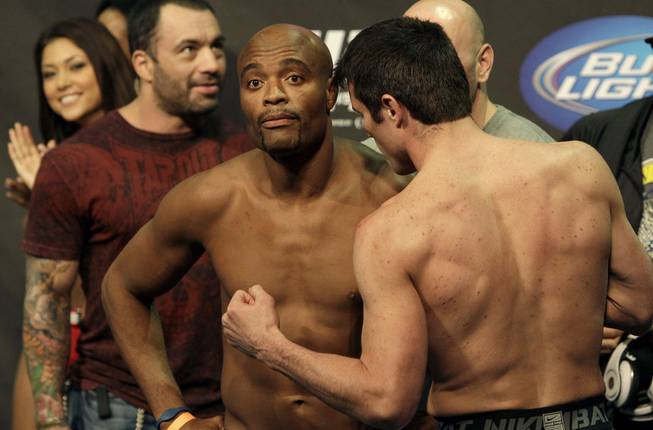 Anderson Silva, center left, and Chael Sonnen face off at a weigh-in event Friday in Oakland, Calif. Silva and Sonnen will fight for Silva's UFC middleweight title at UFC 117 on Saturday.