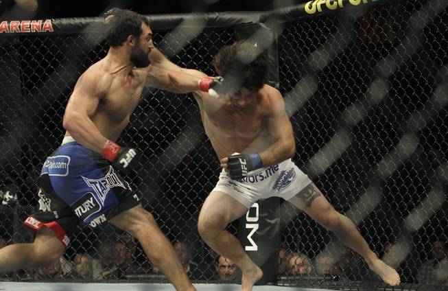 Charlie Brenneman, right, and Johny Hendricks, left, exchange punches at UFC 117 in Oakland, Calif. 