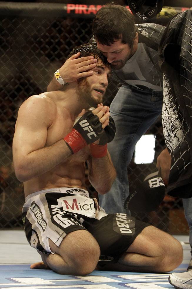 Jon Fitch, left, celebrates after beating Thiago Alves at UFC 117 in Oakland, Calif. Fitch won by unanimous decision.