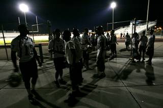 Players gather near the football field before Spring Valley High School's annual midnight football practice Wednesday, August 11, 2010. The practice, which started at 12:01 a.m. Thursday, takes place on the first day high schools can begin football practice.