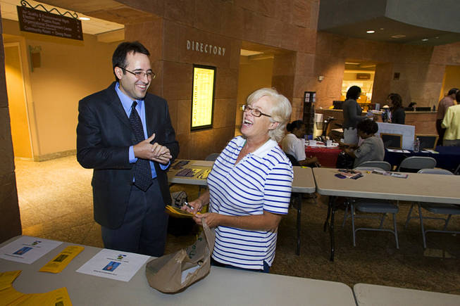 Aaron Honig, a candidate for governor, laughs with county employee Mary Sroczynski during a candidate day on Wednesday at the County Government Center. Honig is an elementary school teacher at Cahlan Elementary School in North Las Vegas. The event is chance for county employees and the public to talk to candidates for public office.