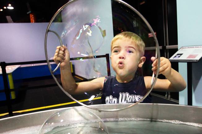 Taj Snavely plays with the bubble feature at Lied Children's Museum Wednesday as the museum announced they will be relocating to the Smith Center for the Performing Arts.