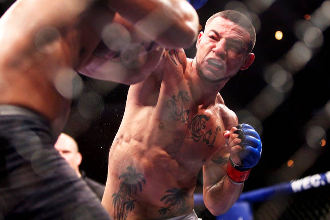 Cub Swanson throws a right at Chad Mendes during their featherweight fights at fight at WEC 50 in this file photo.