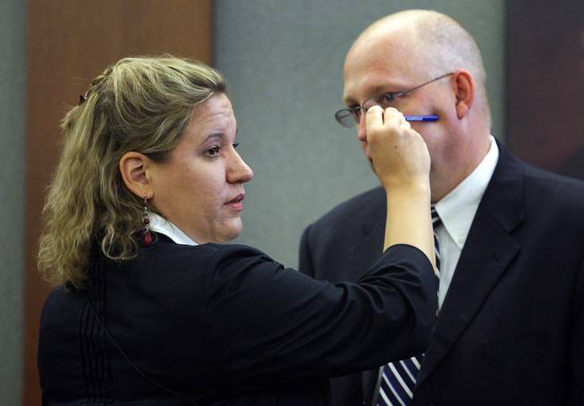 Lisa Gavin, a medical examiner with the Clark County Coroner's Office, uses Clark County Chief Deputy District Attorney Christopher Laurent  to demonstrate where a bullet struck Trevon Cole during a coroner's inquest Friday, August 20, 2010. Cole was shot and killed by Metro Police in June.