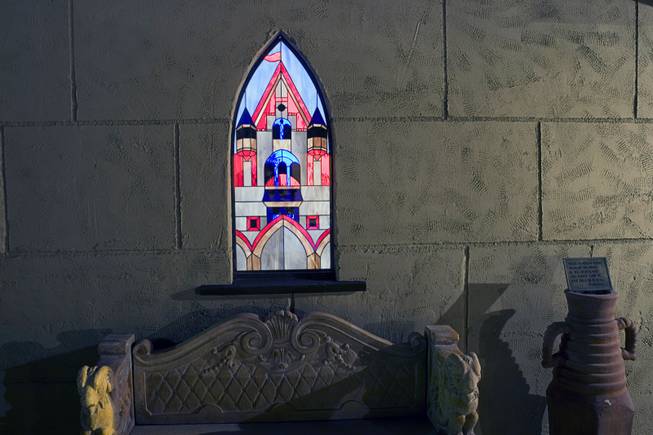 A stained glass window, made by local artisans, is shown ...