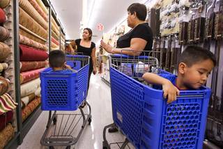 Jennifer Rodriguez, left, shops with her mother, Maria Quiralte, and 4-year-old twins Anthony and David, right, at the new Hobby Lobby in Henderson. The store, the 441st in the chain, opened Monday in a 51,000-square-foot space formerly occupied by a Von's supermarket. Even as many retailers and food establishments are struggling to outlast the recession, new franchises are entering the market or expanding their foothold.