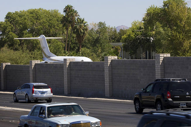 The tail of a jet plane can be seen Tuesday over a wall on the property of entertainer Wayne Newton. Newton, who lives at Pecos and Sunset roads, may create an attraction on the property that could include a museum and a theater where he'll perform after people complete a tour.