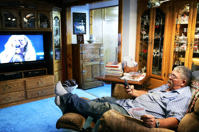 Taking a break between a long day of work on the ranch and dinner, State Assemblyman Pete Goicoechea makes business calls while lounging in "his favorite spot" in his Eureka, Nev., home Wednesday, September 1, 2010.