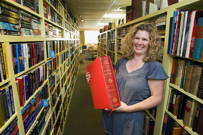 Shereen Hale, owner of the Book Boutique on Pacific Avenue poses with a copy of "The First Folio of Shakespeare: The Norton Facsimile" at her shop in downtown Henderson.