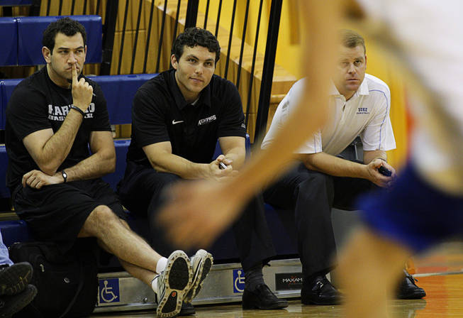 Harvard University assistant coach Yanni Hufnagel, left, Memphis University head coach Josh Pastner, center, and Duke assistant coach Steve Wojciechowski watch an open workout at Bishop Gorman High School Thursday, Sept. 9, 2010. The first day of the fall college basketball recruiting season was Thursday and many college coaches attended to evaluate the talent.