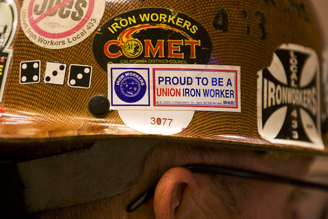 An iron worker wears his helmet during a rally at the Painters and Allied Trades, District Council 15 and Local Union 159, union hall in Henderson Thursday, Sept. 9, 2010. The rally of union members and unemployed workers was held to attack Republican Senate candidate Sharron Angle for her position against "creating" jobs.