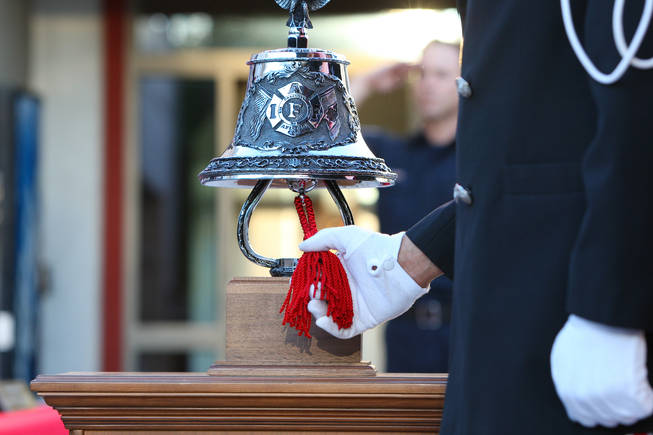 Fire engineer Derick Jones tolls the bell in honor of the first responders who died in the Sept. 11 attacks during a tribute service Saturday at Fire Station 5 in Las Vegas, Sept. 11, 2010.
