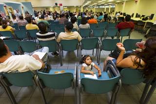 Alyssa Vasquez, 3, waits with her parents Tuesday as they wait to be called to a counter at the East Sahara Avenue Department of Motor Vehicles office.