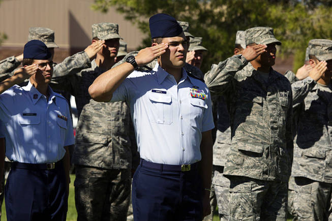 Zach Cantu, center of the Rancho High School ROTC program, salutes during a ceremony to recognize local Prisoners of War and those Missing in Action in honor of National POW/MIA Recognition Day at Nellis Air Force Base Friday, September 17, 2010.  