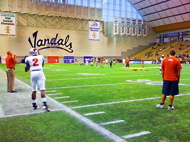 UNLV senior quarterback Omar Clayton (2) warms up with backup Caleb Herring on Saturday night before the Rebels take on the Idaho Vandals at the Kibbie Dome in Moscow, Idaho.
