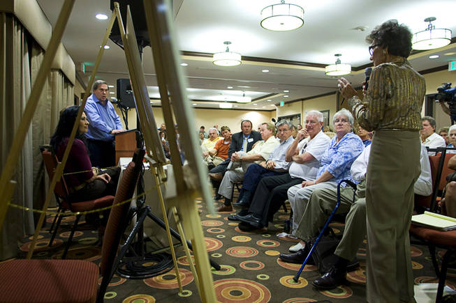 M.J. Harvey, chair of the Paradise Town Board, asks a question during a meeting at the La Quinta Inn Monday, September 20, 2010. Wayne Newton's representative Jay Brown listens at left. Newton hosted the neighborhood meeting to discuss development plans that would include tours on his property.