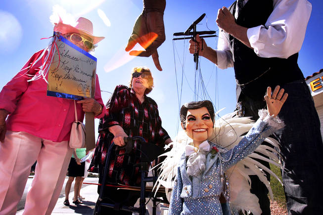 Barbara Winters, from left, Esther Lynn and Joseph Gabriel (with the LIberace puppet) protest the closing of the Liberace Museum in front of the museum in Las Vegas Wednesday, September 22, 2010.