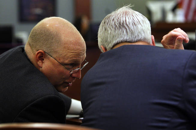 Chief Deputy District Attorney Christopher Laurent, left, confers with Assistant District Attorney Chris Owens during a coroner's inquest for Erik Scott at the Regional Justice Center Friday, September 24, 2010. 