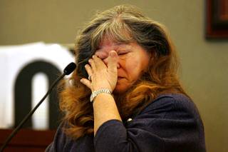 Costco customer Karen Passarelli-Krause wipes away a tear while testifying during a coroner's inquest for Erik Scott at the Regional Justice Center Saturday, September 25, 2010.