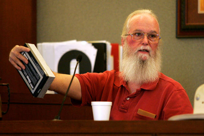 Costco shopper Robert Connolly uses a tissue box to describe the way Erik Scott presented his gun to a Metro officer during a coroner's inquest for Scott at the Regional Justice Center Saturday, September 25, 2010.