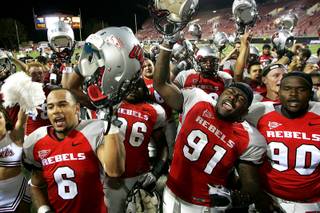 UNLV football players sing the UNLV fight song after defeating New Mexico 45-10 in their Mountain West Conference game Saturday, September 25, 2010. From left are Mike Clausen, James Dunlap, Preston Brooks and Isaiah Shivers.
