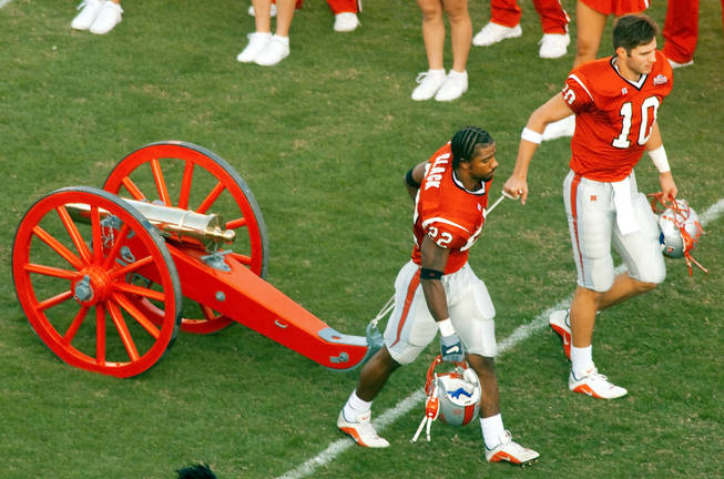UNLV players roll out the refurbished Fremont Cannon two weeks after beating UNR in 2000. Fans broke the cannon in the post-game celebration that year, but the UNLV athletics department repaired it in time for the Rebels next home game against Wyoming. 