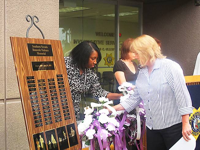 In the past year, 49 people have died as a result of domestic violence in Clark County. Volunteers placed white roses in vases as each victim's name was called during a ceremony Thursday morning organized by Metro Police and the Southern Nevada Domestic Violence Task Force.