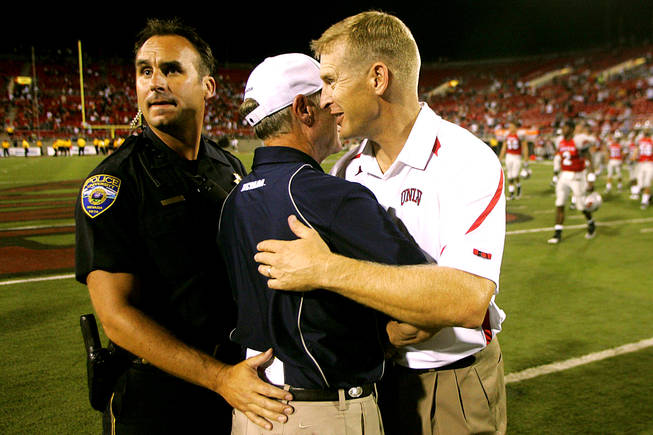 UNLV coach Bobby Hauck congratulates UNR coach Chris Ault after their game on Oct. 3, 2010. UNR won the game, 44-26, to run its win streak over UNLV to six.