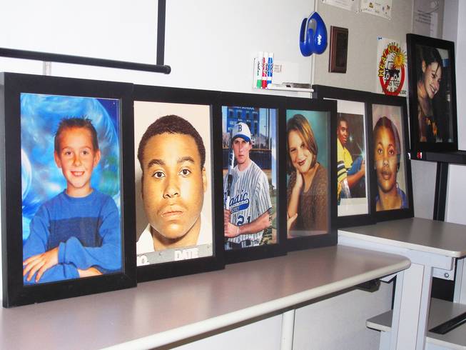 Instructors tell stories of local teenagers, pictured in a row, who died as a result of violent or reckless behavior. "This is where their heads are finally open, and we can put something in it," says Jerry Simon, gang specialist.