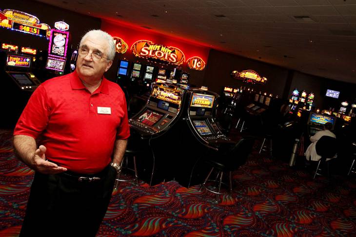 Ron Lurie, general manager of Arizona Charlie's near Decatur and Charleston, shows the enclosed no-smoking area of the casino. Lurie says the $80,000 project included new carpeting, wallpaper and ceiling tiles, as well as a thorough scouring of the 117 machines.
