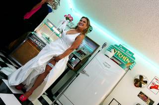 Shelli Mazzone shows off her blue garter and pink shoes before her wedding on 10/10/10 at 10 a.m. at the Viva Las Vegas Wedding Chapel.