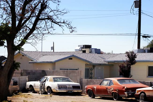 Broken down cars parked in front of a house on ...