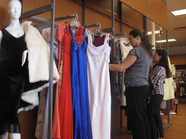 Customers browse the dress racks at the new Opportunity Village Thrift Store, located at 4600 Meadows Lane in the northwest valley.