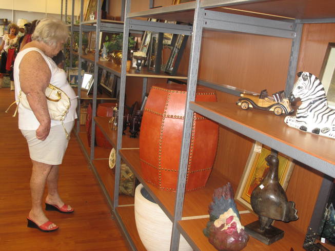 A customer looks at items for sale at the new Opportunity Village Thrift Store. The retail space came with shelving and racks, so only minor painting and cleaning was necessary before the nonprofit organization moved in.