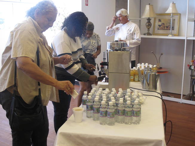 Customers fill up on refreshments before exploring the new Opportunity Village Thrift Shop, located at 4600 Meadows Lane in the northwest valley.
