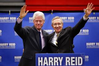 Former President Bill Clinton, left, joins Senate Majority Leader Harry Reid on stage Tuesday during a campaign rally at Valley High School.  Reid is seeking his fifth term in a race against Republican Sharron Angle.