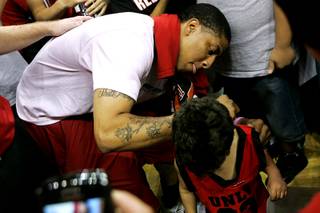 UNLV guard Tre'Von Willis signs a young fan's shirt after their FirstLook scrimmage Friday, October 15, 2010.